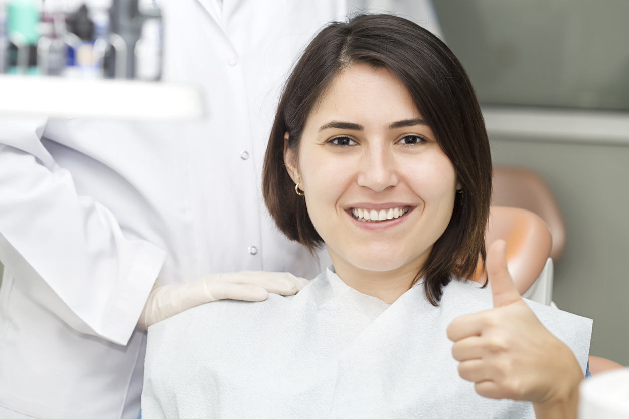 Smiling woman in dental chair: bone grafting
